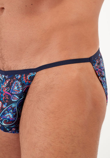 male model wearing colorful men's underwear with a paisley pattern on a white background